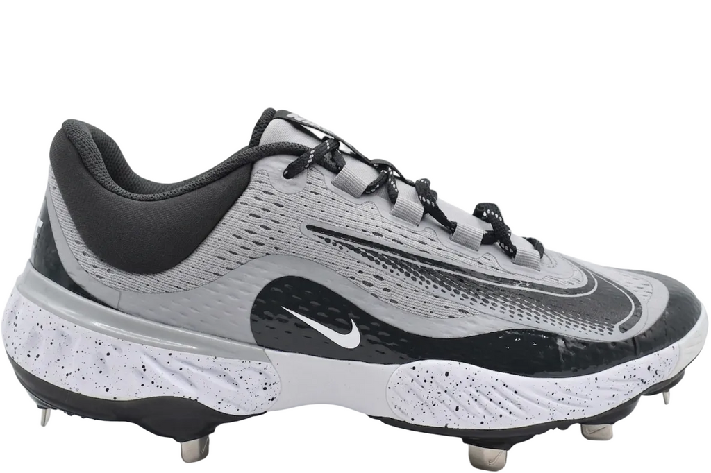 Nike Alpha Huarache Elite 4 Low Baseball Cleats in Wolf Grey and Dark Smoke Grey, showing the side profile and signature Nike Swoosh.