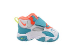 Side profile view of Nike Speed Turf TD sneakers showing the retro midfoot strap and turquoise accents, BV2525-101.
