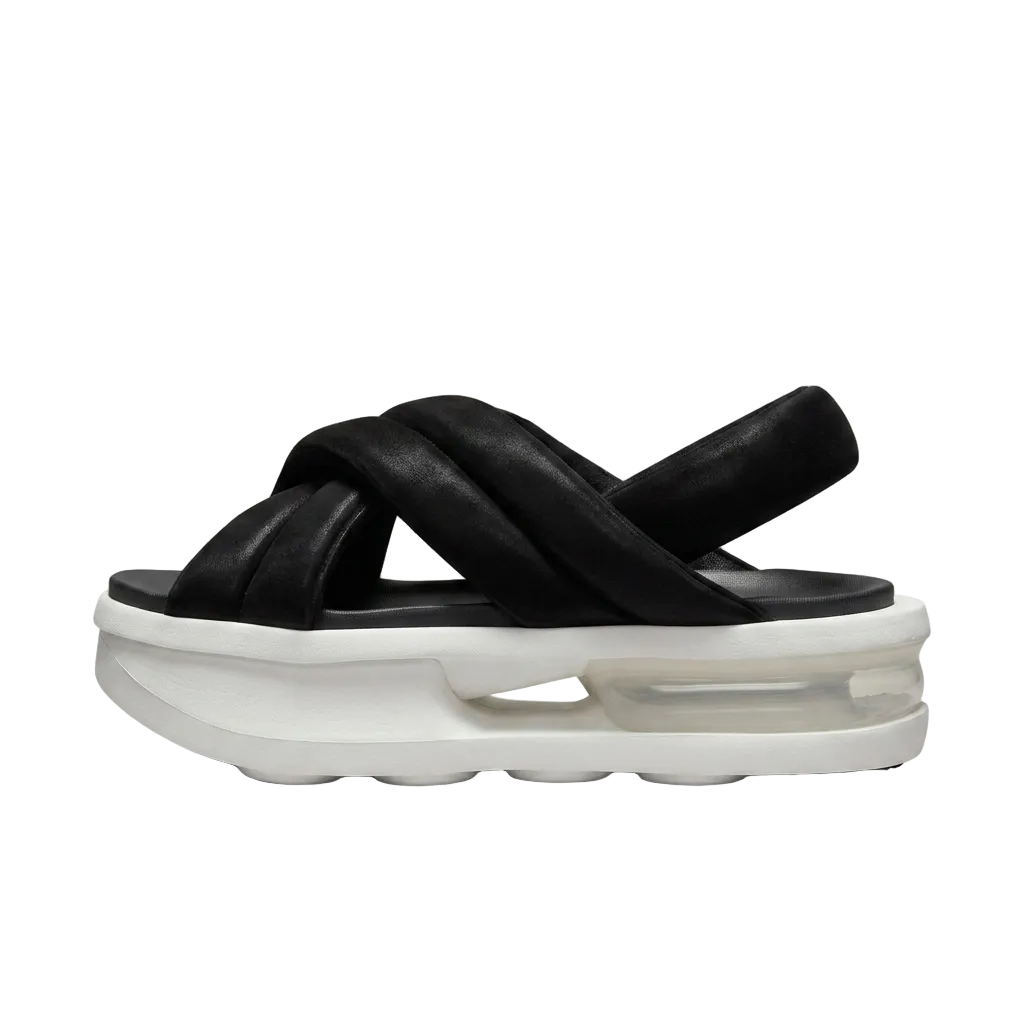 Side profile view of Nike Air Max Isla chunky slip-on sandals highlighting the thick crossover padded strap design, FJ5929-002.