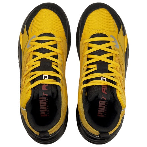 Top down view of the J Cole Puma RS Dreamer 2 Mid junior basketball shoe showcasing the yellow knit upper, black laces, and tongue branding.
